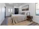 Comfortable bedroom offers natural light, neutral colors, and plank flooring at 3105 N Elizabeth St, Denver, CO 80205