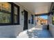 Stylish covered front porch with brick detailing, offering a welcoming and shaded outdoor space at 3105 N Elizabeth St, Denver, CO 80205