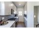Galley kitchen features stainless steel appliances, shaker cabinets, modern backsplash, and hardwood floors at 3105 N Elizabeth St, Denver, CO 80205