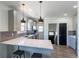 Stylish kitchen features shaker cabinets, stainless appliances, and a quartz countertop island with pendant lighting at 3105 N Elizabeth St, Denver, CO 80205