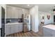 Stainless steel refrigerator and cabinets accent the open kitchen with hardwood floors and bright light at 3105 N Elizabeth St, Denver, CO 80205