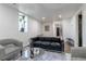 Modern living room with a black leather couch and contemporary furnishings at 3105 N Elizabeth St, Denver, CO 80205