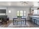 Open-concept living and dining area with hardwood floors, a modern chandelier, and ample seating at 3105 N Elizabeth St, Denver, CO 80205