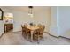 Cozy dining area featuring a wooden table, six chairs, and contemporary pendant lighting at 1604 Brookside Dr, Highlands Ranch, CO 80126