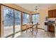 Sun-drenched eat-in dining area with access to the wood deck and backyard at 1604 Brookside Dr, Highlands Ranch, CO 80126