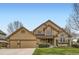Inviting two-story home with a well-manicured lawn and an attached two-car garage at 1604 Brookside Dr, Highlands Ranch, CO 80126