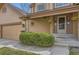 A welcoming front entrance with potted plants, and a covered porch with hanging baskets at 1604 Brookside Dr, Highlands Ranch, CO 80126