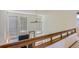 Bright hallway features large windows, a ceiling fan, and wooden banister at 1604 Brookside Dr, Highlands Ranch, CO 80126