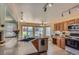 Sun-filled eat-in kitchen featuring granite countertops, stainless dishwasher, and backyard views at 1604 Brookside Dr, Highlands Ranch, CO 80126