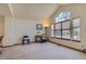 Bright living room featuring vaulted ceilings and large windows offering ample natural light at 1604 Brookside Dr, Highlands Ranch, CO 80126