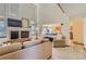 Open-concept living room with high ceilings, fireplace, and view of the kitchen at 1604 Brookside Dr, Highlands Ranch, CO 80126
