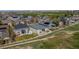 Aerial view of the property showcases the backyard patio and the surrounding neighborhood at 401 Clubhouse Dr, Fort Lupton, CO 80621