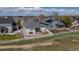 Aerial view of home, fence, and yard with a patio and golf course at 401 Clubhouse Dr, Fort Lupton, CO 80621