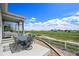Relax on the covered back patio with views of the fenced in yard and open fields beyond at 401 Clubhouse Dr, Fort Lupton, CO 80621