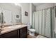 Bathroom featuring single sink vanity with a shower and bathtub combo at 401 Clubhouse Dr, Fort Lupton, CO 80621