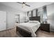 This bedroom boasts hardwood floors, a ceiling fan, and an ensuite bathroom with a glass door shower at 401 Clubhouse Dr, Fort Lupton, CO 80621
