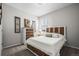Comfortable bedroom with soft carpet, a large bed with drawers, and natural light from the window at 401 Clubhouse Dr, Fort Lupton, CO 80621