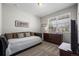 Neutral bedroom featuring carpet, a window for natural light, and dark wood furniture at 401 Clubhouse Dr, Fort Lupton, CO 80621