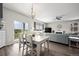 Cozy dining area with a white table set for four, sliding glass door to the backyard at 401 Clubhouse Dr, Fort Lupton, CO 80621