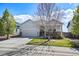 Charming single Gathering home with a two car garage, landscaped yard, and covered front porch at 401 Clubhouse Dr, Fort Lupton, CO 80621
