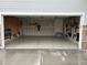 Spacious two-car garage with epoxy floors, storage, and convenient interior access door at 401 Clubhouse Dr, Fort Lupton, CO 80621