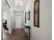 Hallway boasts hardwood floors, decorative wall art, and a view of the front door at 401 Clubhouse Dr, Fort Lupton, CO 80621