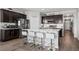 Modern kitchen with white countertops, stainless steel appliances, and stylish dark wood cabinets at 401 Clubhouse Dr, Fort Lupton, CO 80621