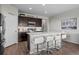 Modern kitchen with white countertops, dark cabinets, stainless steel appliances, and bar seating at 401 Clubhouse Dr, Fort Lupton, CO 80621