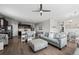 Open concept living room with view to kitchen, dining area, and outdoor scenery at 401 Clubhouse Dr, Fort Lupton, CO 80621