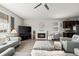 Open floor plan with living room featuring a fireplace, TV, and connection to kitchen at 401 Clubhouse Dr, Fort Lupton, CO 80621