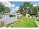 Spacious backyard with a detached garage and ample green space, perfect for outdoor activities at 9150 Fir Dr, Thornton, CO 80229