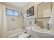Bright bathroom with tiled walls, bathtub, shower, and a vanity with ample counter space at 9150 Fir Dr, Thornton, CO 80229