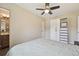 Spacious bedroom featuring a ceiling fan, closet, and access to the bathroom at 9150 Fir Dr, Thornton, CO 80229