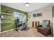 Inviting bedroom featuring green accent wall, plush carpet, floating shelves and natural light at 9150 Fir Dr, Thornton, CO 80229