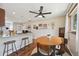 The dining room features wood floors, a ceiling fan, and is connected to a kitchen island at 9150 Fir Dr, Thornton, CO 80229