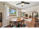 Open-concept dining area flows into the living room, featuring hardwood floors and large windows at 9150 Fir Dr, Thornton, CO 80229