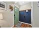 Modern entryway with painted accent wall, hooks and wood-look flooring at 9150 Fir Dr, Thornton, CO 80229