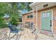 Inviting front yard featuring stone patio, seating area, and a well-manicured lawn at 9150 Fir Dr, Thornton, CO 80229