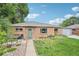 Charming brick home with a well-manicured lawn, walkway, and green front door at 9150 Fir Dr, Thornton, CO 80229
