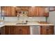 Well-lit kitchen with wooden cabinets, stainless steel dishwasher, and light countertops at 9150 Fir Dr, Thornton, CO 80229