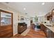 Spacious open-plan kitchen with wood cabinets, stainless appliances, and view to dining area at 9150 Fir Dr, Thornton, CO 80229