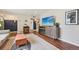 Bright living room with modern furnishings, stylish rug, and a TV with fireplace console at 9150 Fir Dr, Thornton, CO 80229