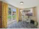 Bright office featuring a desk, patterned rug, and french doors leading to the backyard at 9150 Fir Dr, Thornton, CO 80229