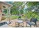 Charming patio with stone flooring, seating, and a view of the landscaped front yard at 9150 Fir Dr, Thornton, CO 80229