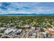 Breathtaking aerial perspective of a city, featuring lush greenery and distant mountain peaks under a blue sky at 930 Parkview St, Louisville, CO 80027