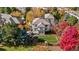Gorgeous aerial view of home showcasing a private fenced yard, patio area, and lush fall foliage surroundings at 2 Fieldstone Trl, Englewood, CO 80113