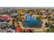 Breathtaking aerial view of a community lake surrounded by vibrant fall foliage and luxurious homes at 2 Fieldstone Trl, Englewood, CO 80113