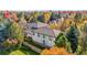 Captivating aerial view of the home surrounded by colorful autumn trees offering serene privacy and natural beauty at 2 Fieldstone Trl, Englewood, CO 80113