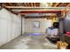Unfinished basement with exposed ceiling, concrete floor, and a window, offering potential for customization at 2 Fieldstone Trl, Englewood, CO 80113