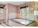 Elegant bathroom with large soaking tub and separate walk-in shower behind glass door at 2 Fieldstone Trl, Englewood, CO 80113